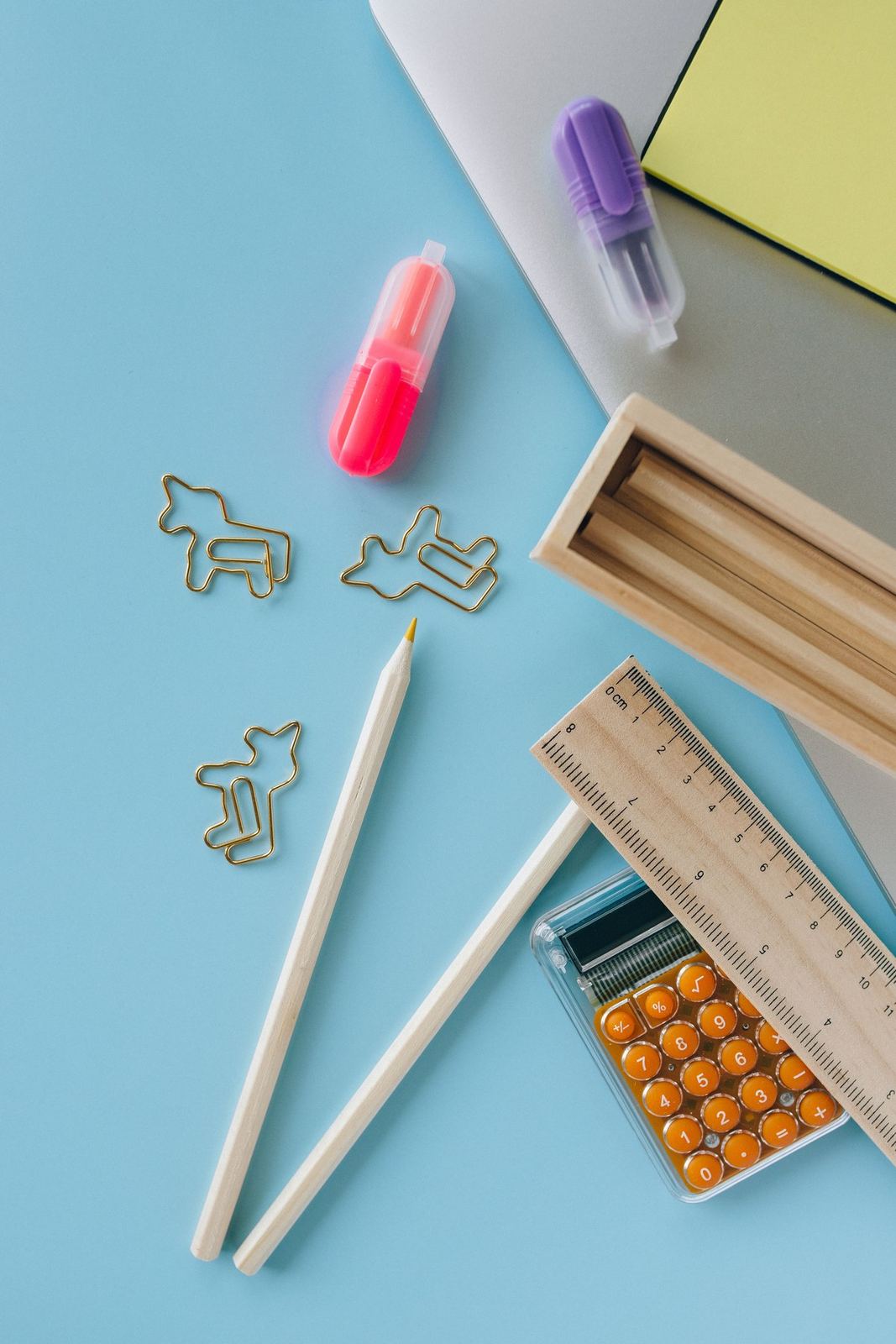 Colorful school supplies arranged on a blue surface