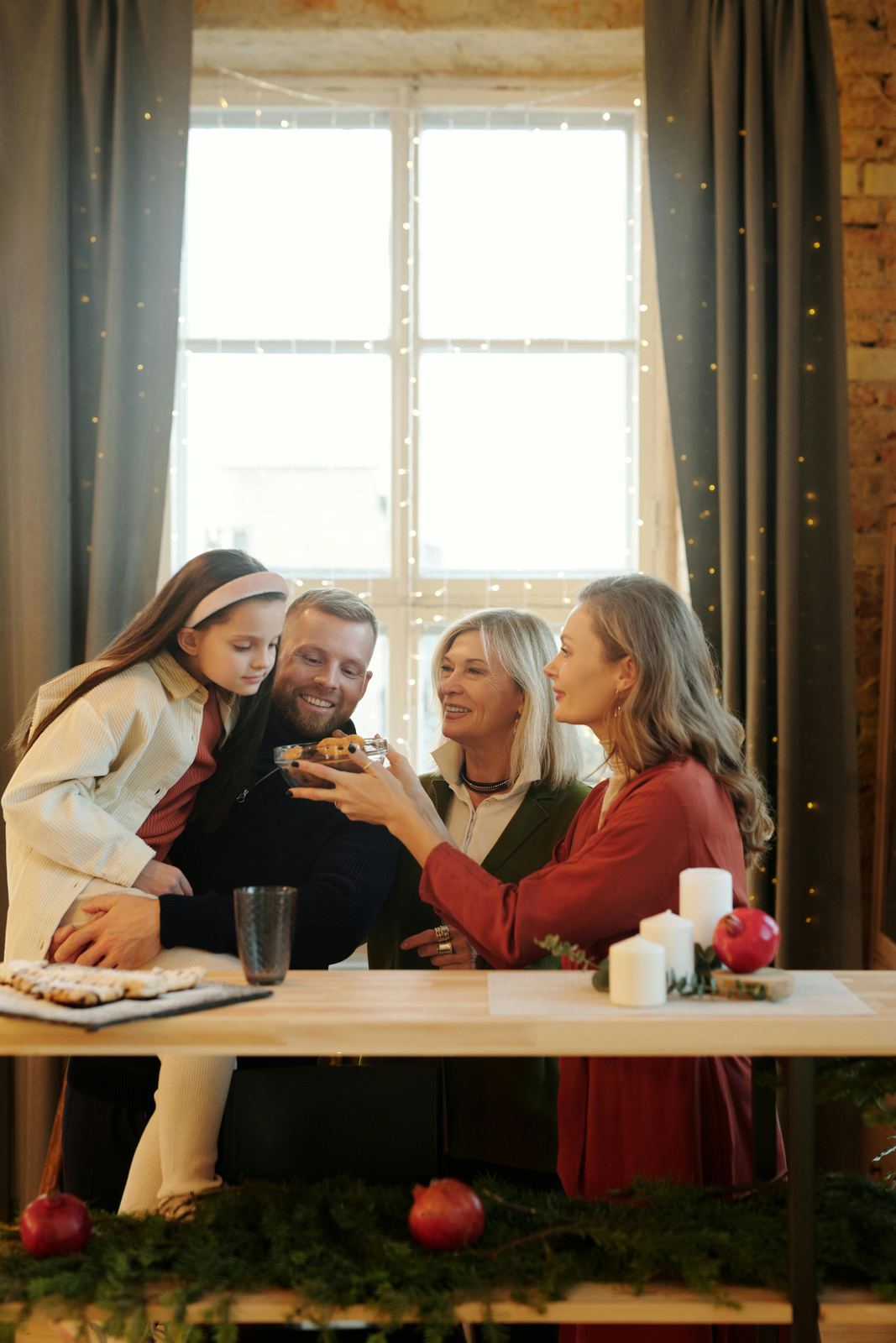 Family sits together at a table, sharing a moment.