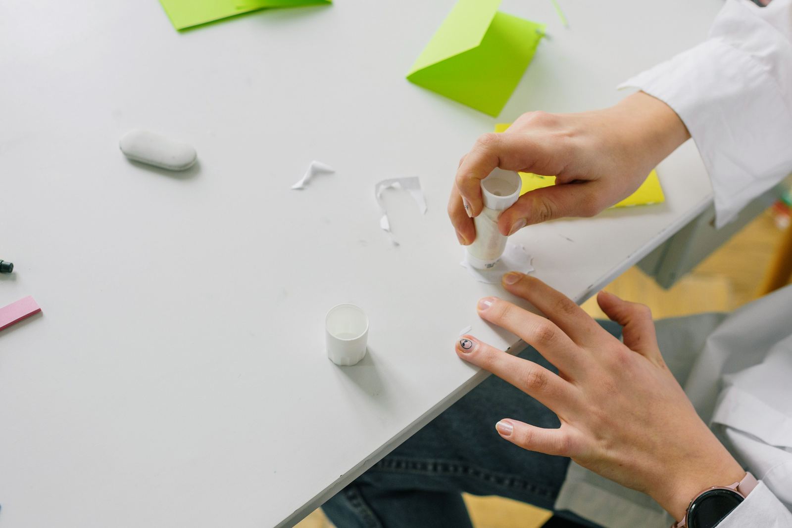 Hand applying glue on paper for a craft