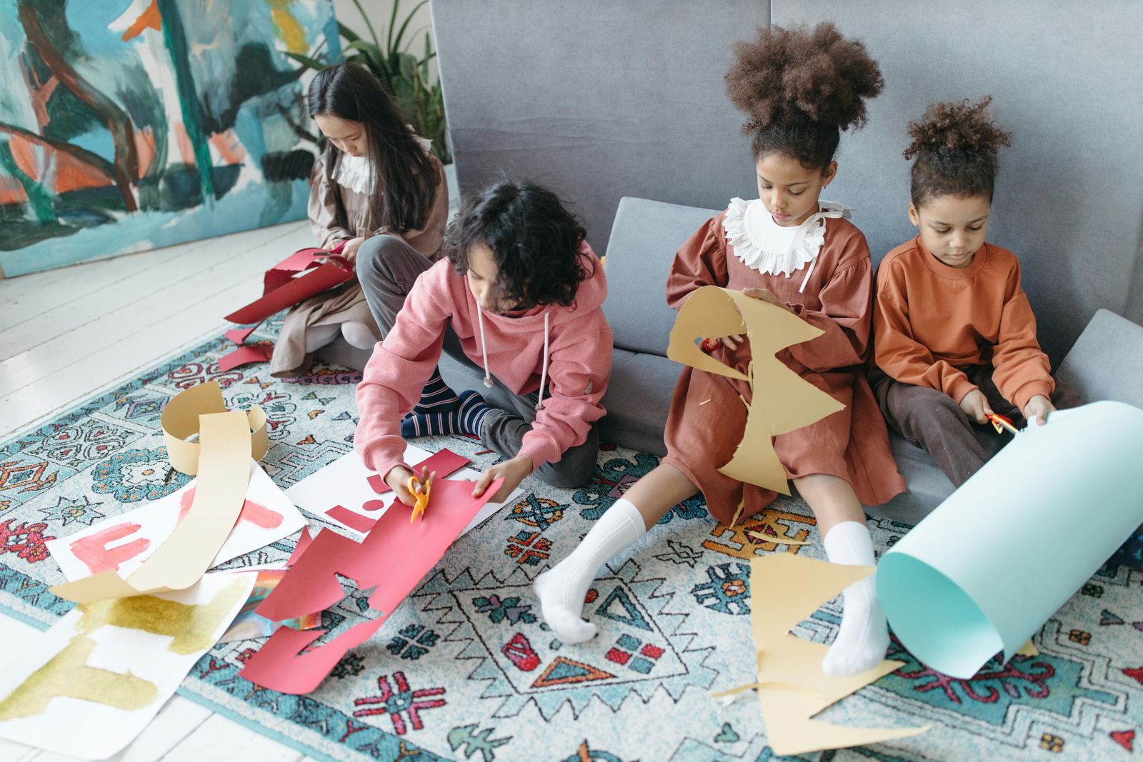 Children cutting colored paper during a creative activity