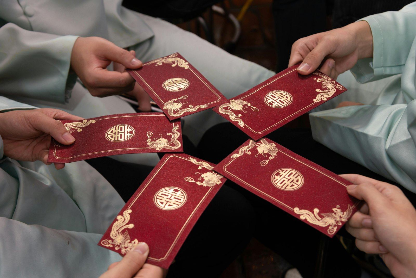 People exchanging red envelopes during a celebration.