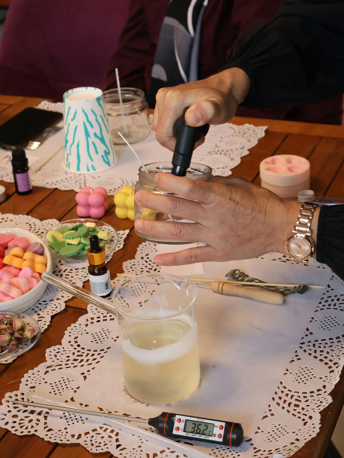 Candle making workshop with thermometer and tools