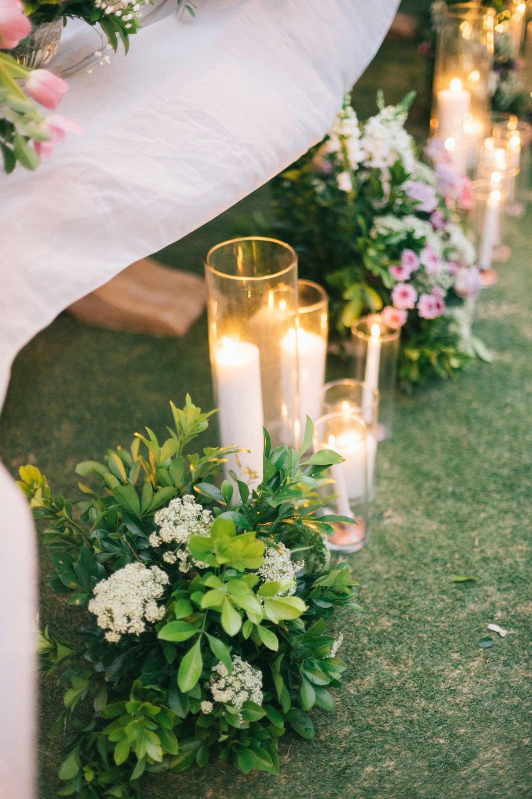 Ceremony aisle decorated with candles and white flowers