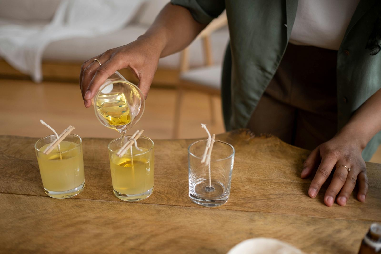 Liquid wax poured into jars to make candles